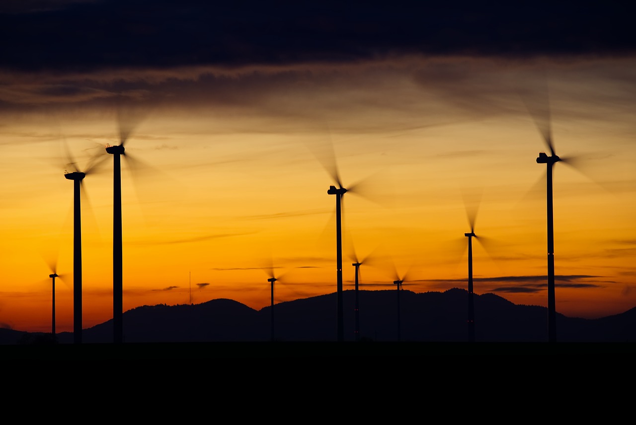 Wind turbines silhouetted at sunset